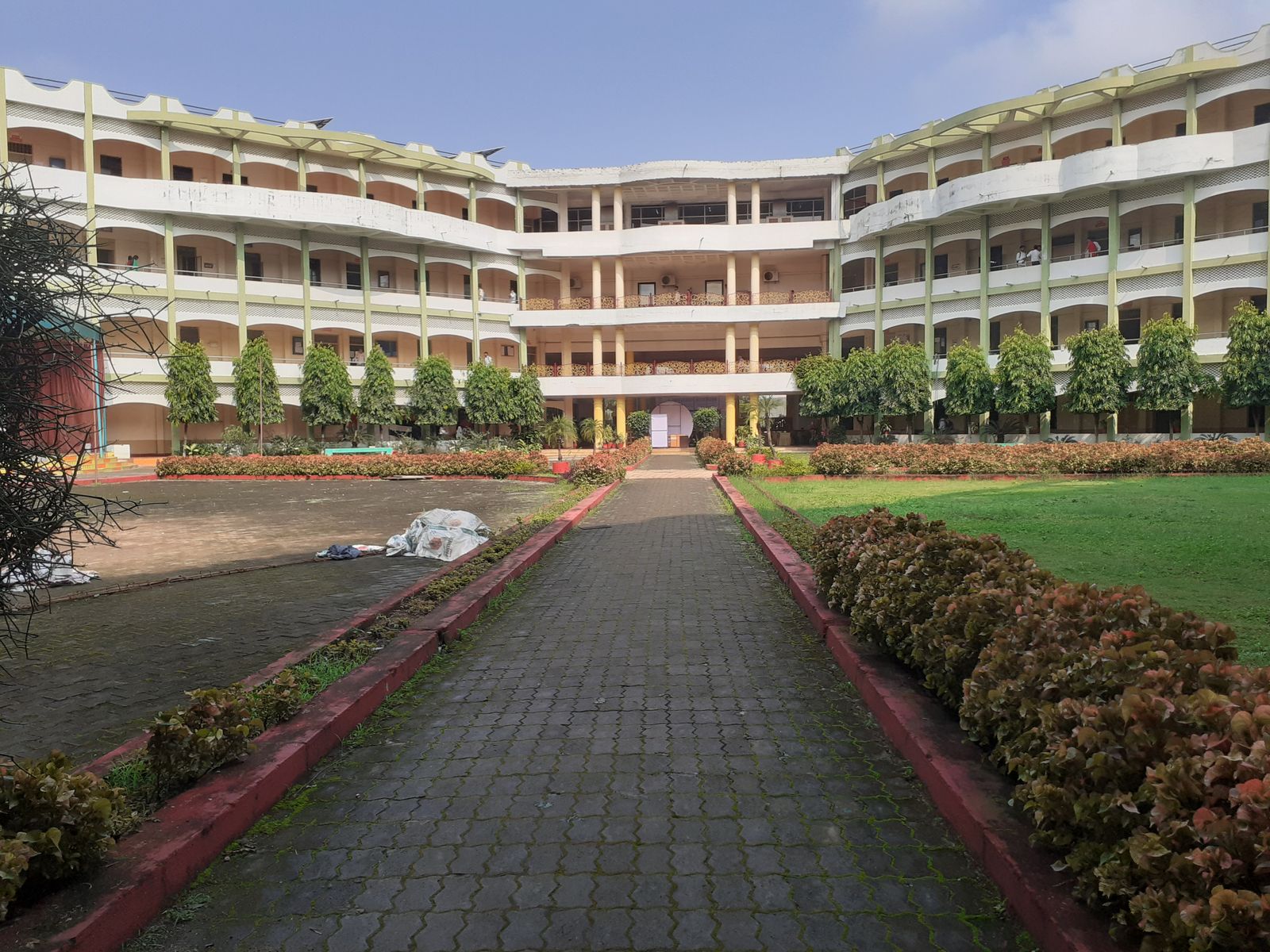School building with a garden pathway leading to the entrance