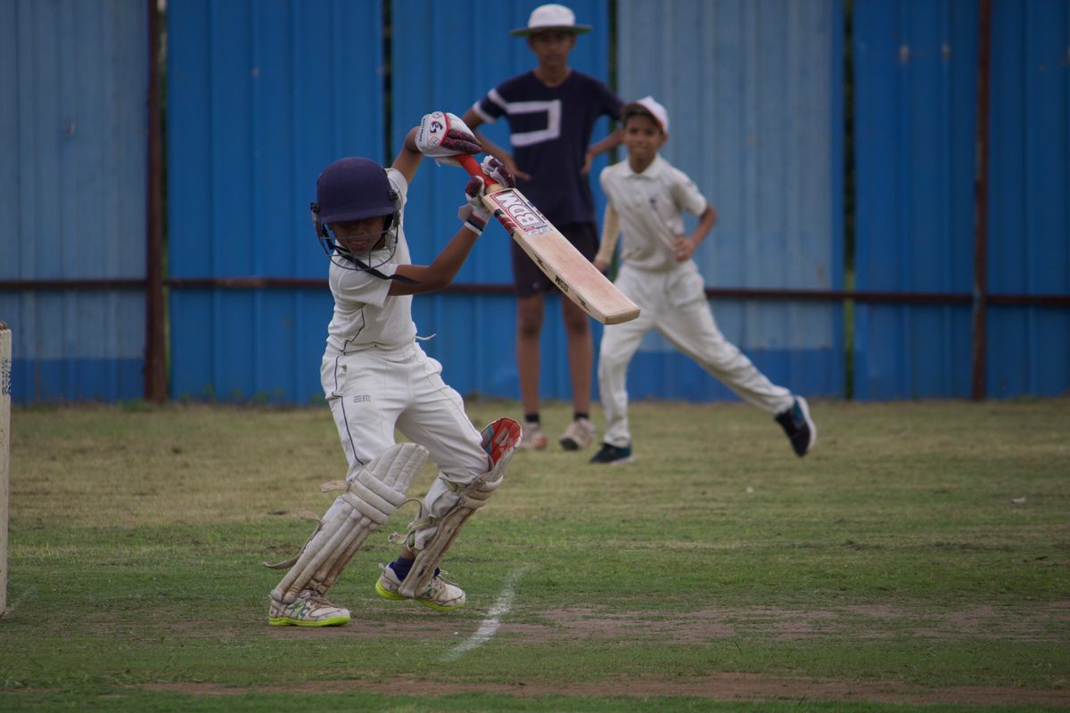 Young cricketer batting during a match