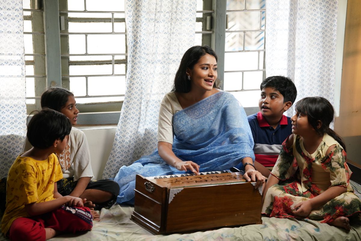 Teacher playing the harmonium during a music lesson