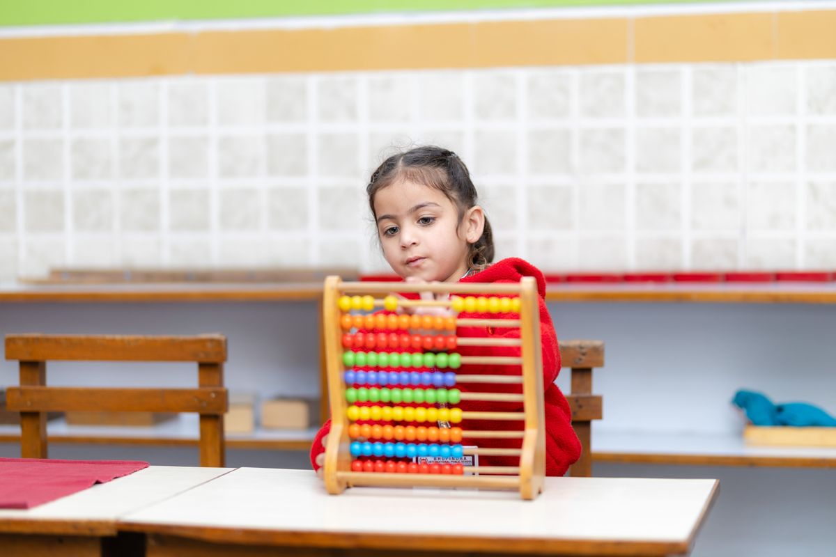 Pre-primary student learning to count with an abacus