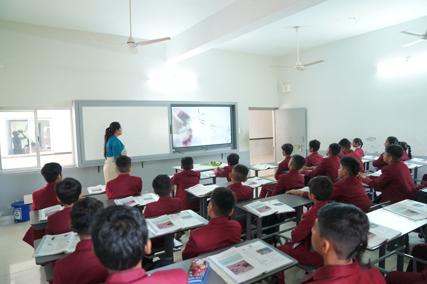 Students in a smart classroom with an interactive display