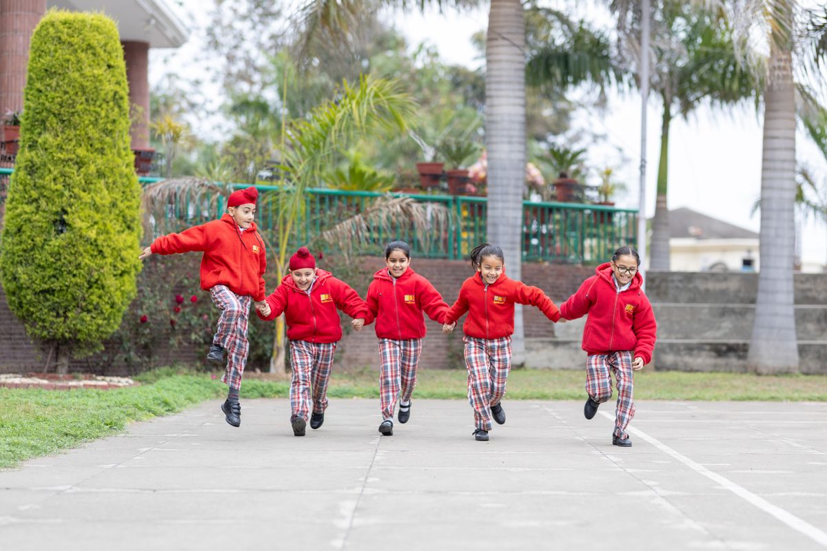 Primary students running together on the school ground